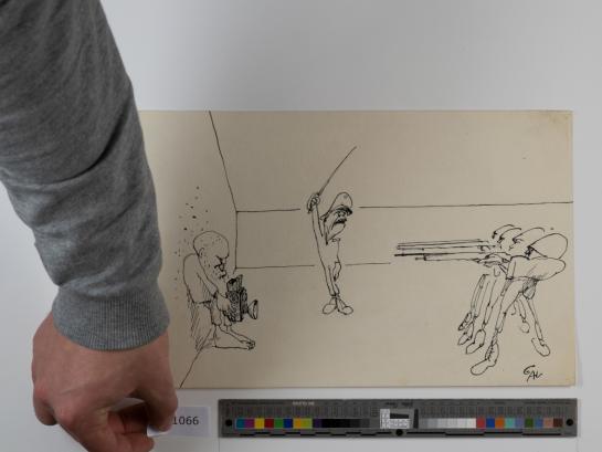 Een foto van het digitaliseringsvlak met een tekening van GAL, target en medewerker die collectienummer plaatst